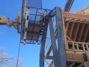 Installation of steel I-beam moment frame to provide structural support for home due to extensive use of glass and windows.