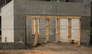 plywood formed poured cement concrete T-mass walls storm proof building